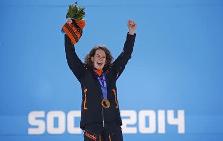 Gold medalist Irene Wust of Netherlands celebrates on the podium during the medal ceremony for the women's 3000 meters speed skating race at the 2014 Sochi Winter Olympics February 10, 2014. REUTERS/David Gray