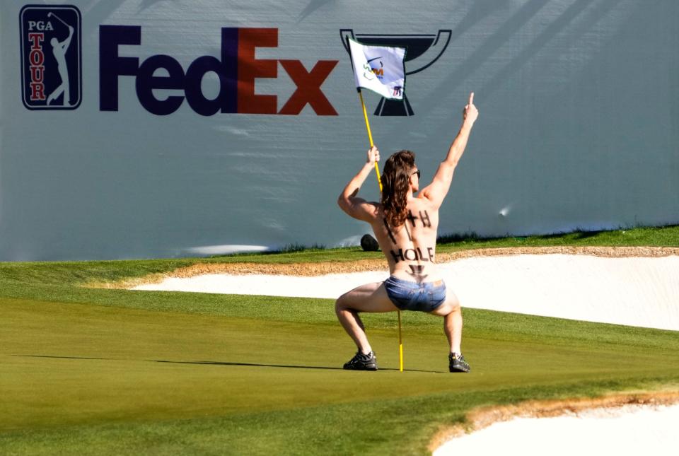 Feb 10, 2023; Scottsdale, AZ, USA; A man runs onto the 16th green delaying the tee shot of Stewart Cink during round two at TPC Scottsdale. Mandatory Credit: Rob Schumacher-Arizona Republic