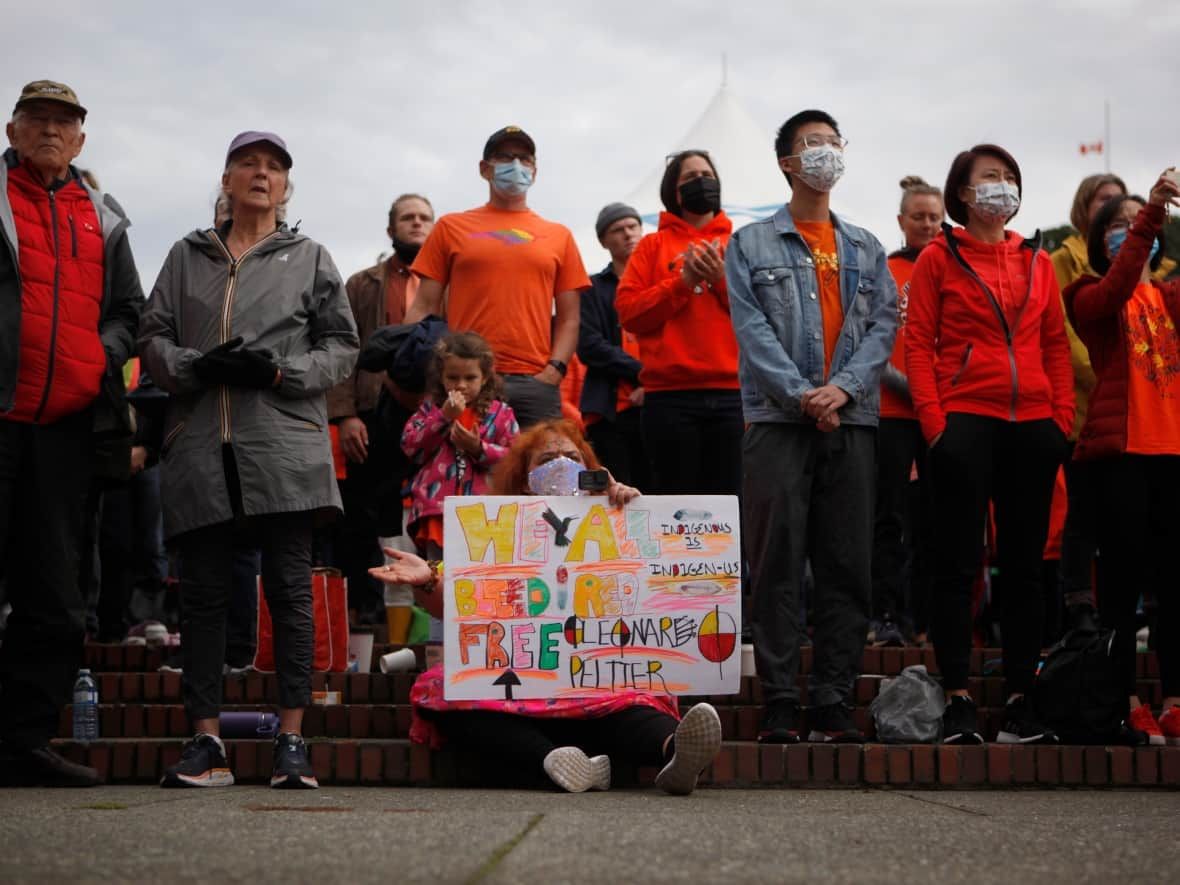 People attend the Xe Xe Smun’eem-Victoria Orange Shirt Day Every Child Matters ceremony to honour residential school victims at Centennial Square in Victoria, on Sept. 30, 2021. (Chad Hipolito/The Canadian Press - image credit)