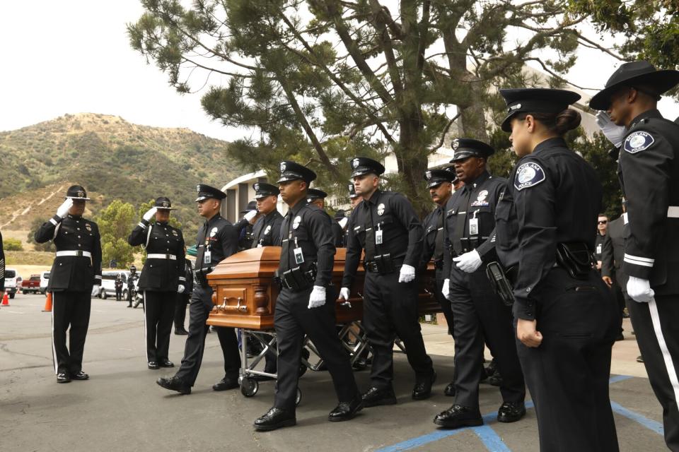 LAPD officers carry the casket of colleague, Houston Tipping.