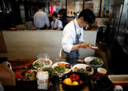 Chefs prepare dishes at HyLife Pork Table, a pork dish restaurant operated by Canadian pig farmer and pork processor HyLife, at Daikanyama district in Tokyo, Japan October 31, 2016. REUTERS/Issei Kato