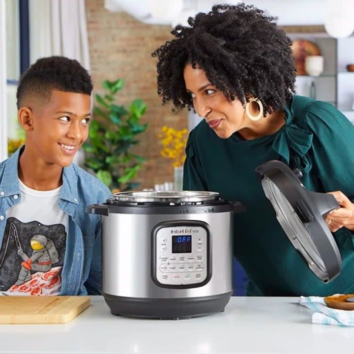 Two people standing by instant pot