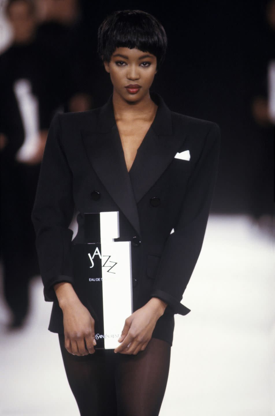 <p>Here, Naomi Campbell walked the YSL catwalk in this black mini blazer dress. </p>