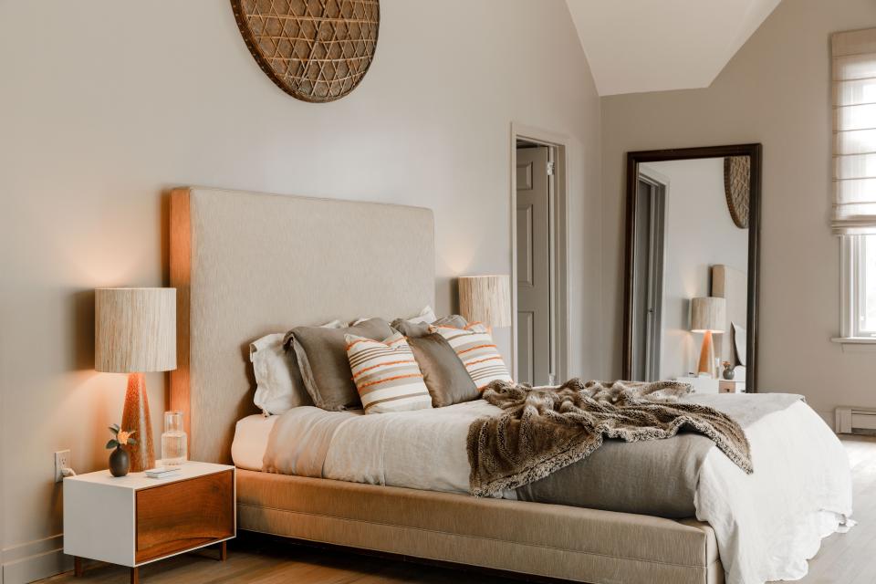 The couple’s bedroom is done in a palette of neutrals with a pop of orange. The silk platform bed is a custom piece from Richter Design and paired with bedlinens from Arhaus. Everick designed the striped throw pillows himself. The custom Corian-wrapped walnut nightstands are from Patrick Weder Design, topped with hand-carved palm-wood table lamps from Chista NY.