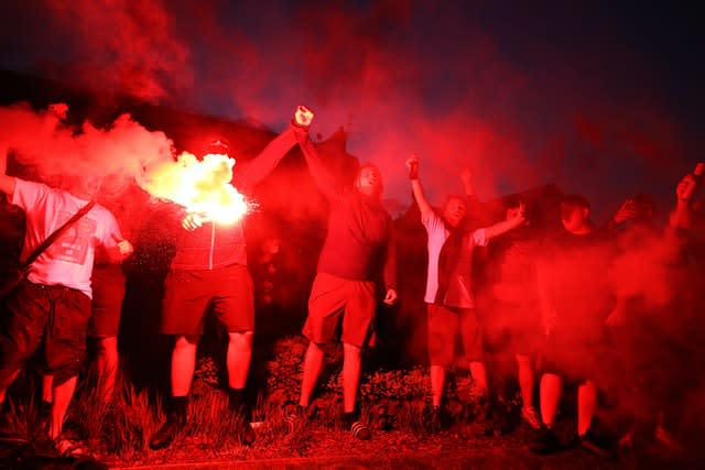 Liverpool fans let off flares outside Anfield as they celebrated being crowned champions 