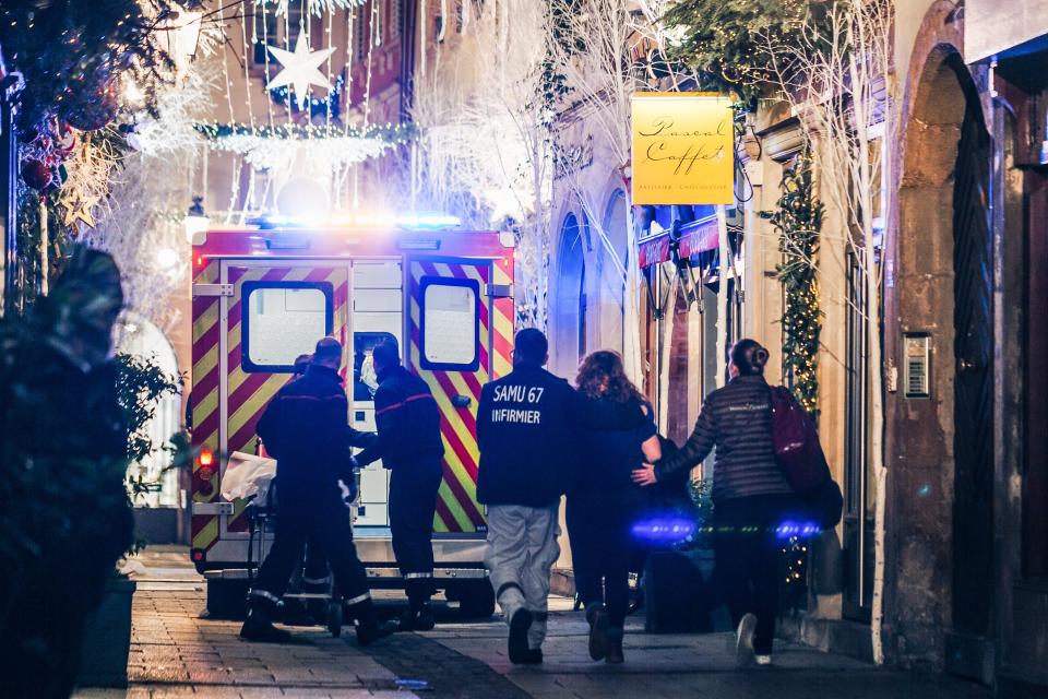 Emergency workers escort a woman after a shooting near the Christmas market in Strasbourg, eastern France, on Dec.11, 2018. (Photo: <span>Abdesslam Mirdass</span>/AFP/Getty Images)