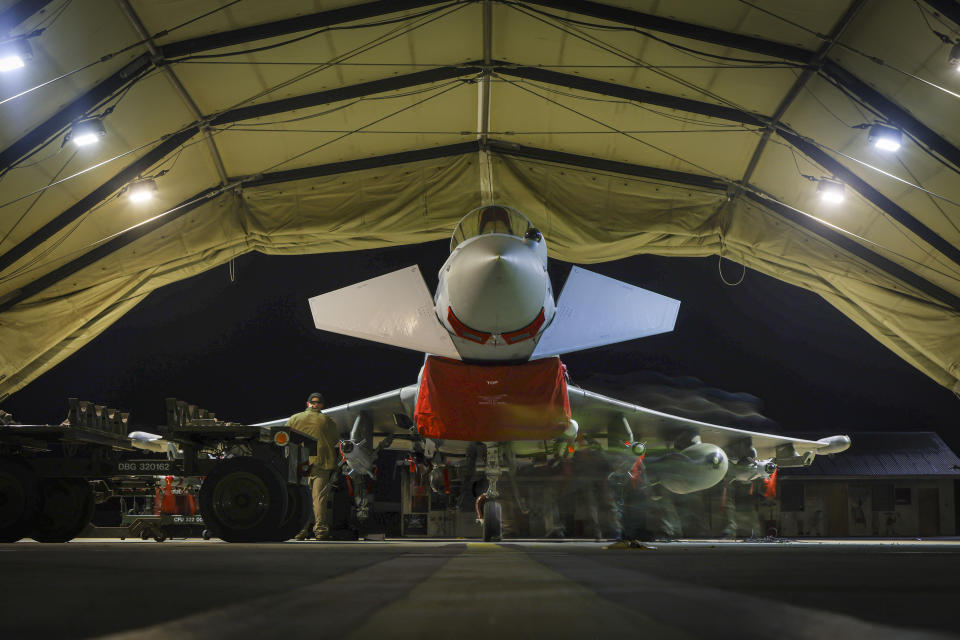 In this image provided by the UK Ministry of Defence, RAF Armourers (Weapon Technicians) prepare a Royal Air Force Typhoon FGR4 for air strikes against Houthi military targets in Yemen, in RAF Akrotiri, Sunday, Jan. 21, 2024. The U.S. and British militaries bombed eight locations used by the Iranian-backed Houthis in Yemen on Monday night, the second time the two allies have conducted coordinated retaliatory strikes on an array of the rebels' missile-launching capabilities. (AS1 Leah Jones/Ministry of Defence via AP)