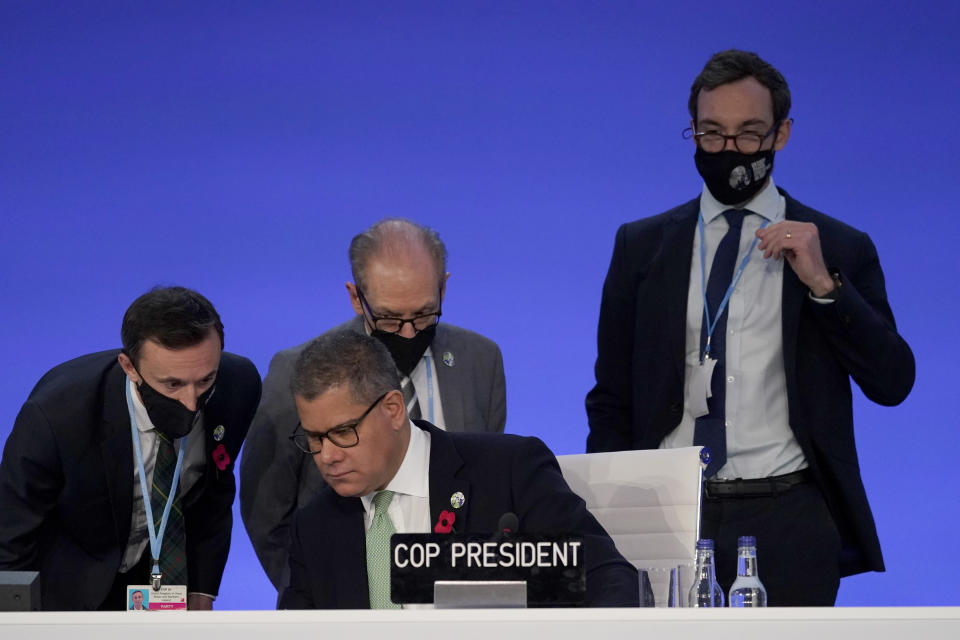 Alok Sharma, centre seated, President of the COP26 summit attends a stocktaking plenary session at the COP26 U.N. Climate Summit, in Glasgow, Scotland, Saturday, Nov. 13, 2021. Going into overtime, negotiators at U.N. climate talks in Glasgow are still trying to find common ground on phasing out coal, when nations need to update their emission-cutting pledges and, especially, on money. (AP Photo/Alberto Pezzali)