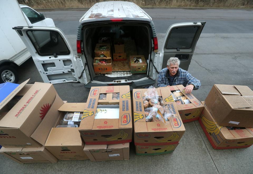Monte Hurd, a volunteer loads a van with food donated by Wegmans to be taken back to the Sent By Ravens Food Pantry in Livonia.  Many grocery and retail stores in the area donate food to local food pantries and farms in their communities. 