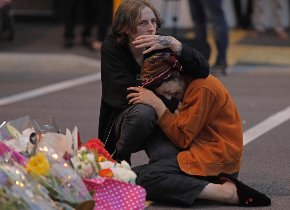 Mourners pay their respects at a makeshift memorial near the Masjid Al Noor mosque in Christchurch, New Zealand, Saturday, March 16, 2019. New Zealand’s stricken residents reached out to Muslims in their neighborhoods and around the country on Saturday, in a fierce determination to show kindness to a community in pain as a 28-year-old white supremacist stood silently before a judge, accused in mass shootings at two mosques that left dozens of people dead.(AP Photo/Vincent Yu)