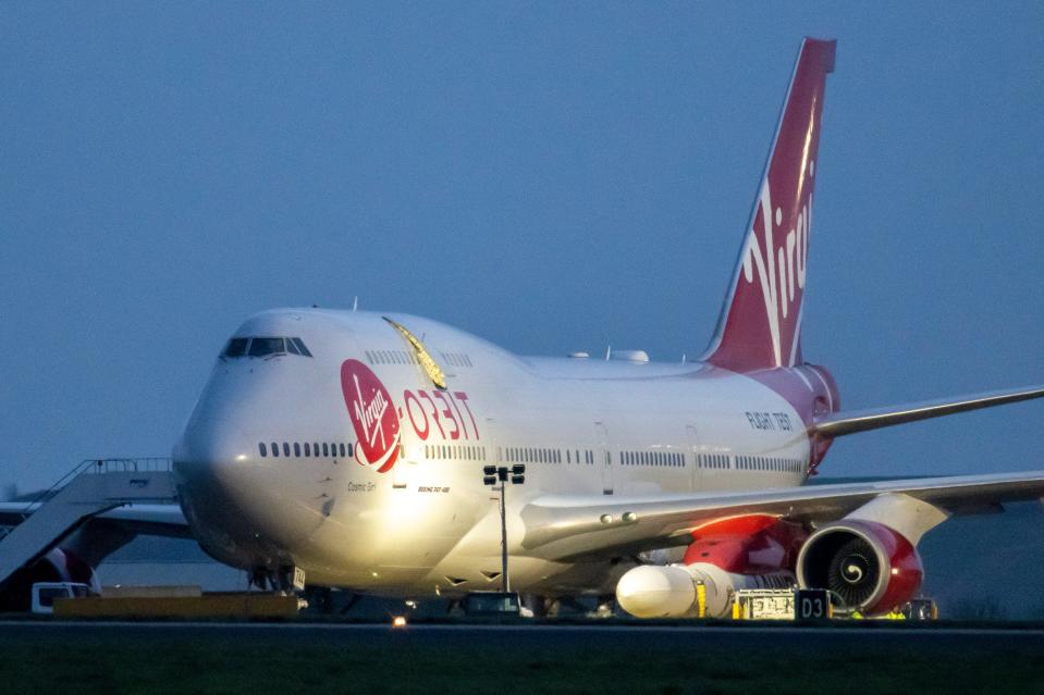 A general view of Cosmic Girl, a Boeing 747-400 aircraft carrying the LauncherOne rocket under its left wing, as final preparations are made at Cornwall Airport Newquay on January 9, 2023 in Newquay, United Kingdom.