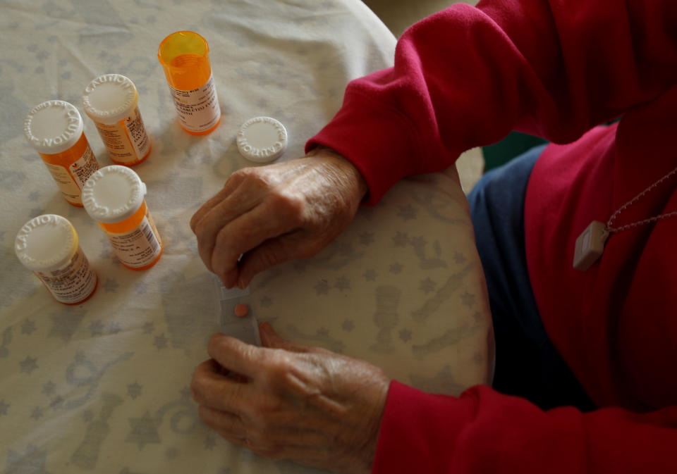 Inez Willis, a senior citizen, sorts her daily medical prescriptions at her independent living apartment in Silver Spring, Maryland April 11, 2012. REUTERS/Gary Cameron   (UNITED STATES - Tags: SOCIETY HEALTH)