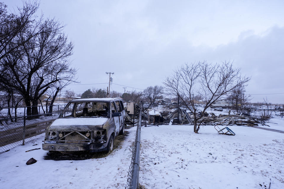 A charred vehicle sits on the driveway of a home destroyed by the Smokehouse Creek Fire, Thursday, Feb. 29, 2024, in Stinnett, Texas. (AP Photo/Julio Cortez)