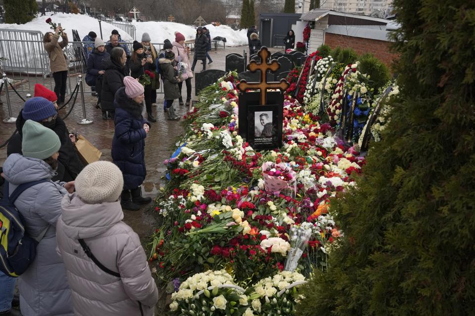 People gather to lay flowers at the grave of Alexei Navalny the day after his funeral at the Borisovskoye Cemetery, in Moscow, Russia, on Saturday, March 2, 2024. Navalny, who was President Vladimir Putin's fiercest foe, was buried after a funeral that drew thousands of mourners amid a heavy police presence. (AP Photo)