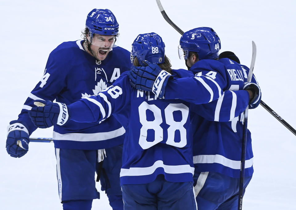 Toronto Maple Leafs forward William Nylander (88) celebrates his goal against the Montreal Canadiens with forward Auston Matthews (34) and Morgan Rielly (44) during the third period of Game 2 of an NHL hockey Stanley Cup first-round playoff series Saturday, May 22, 2021, in Toronto. (Nathan Denette/The Canadian Press via AP)