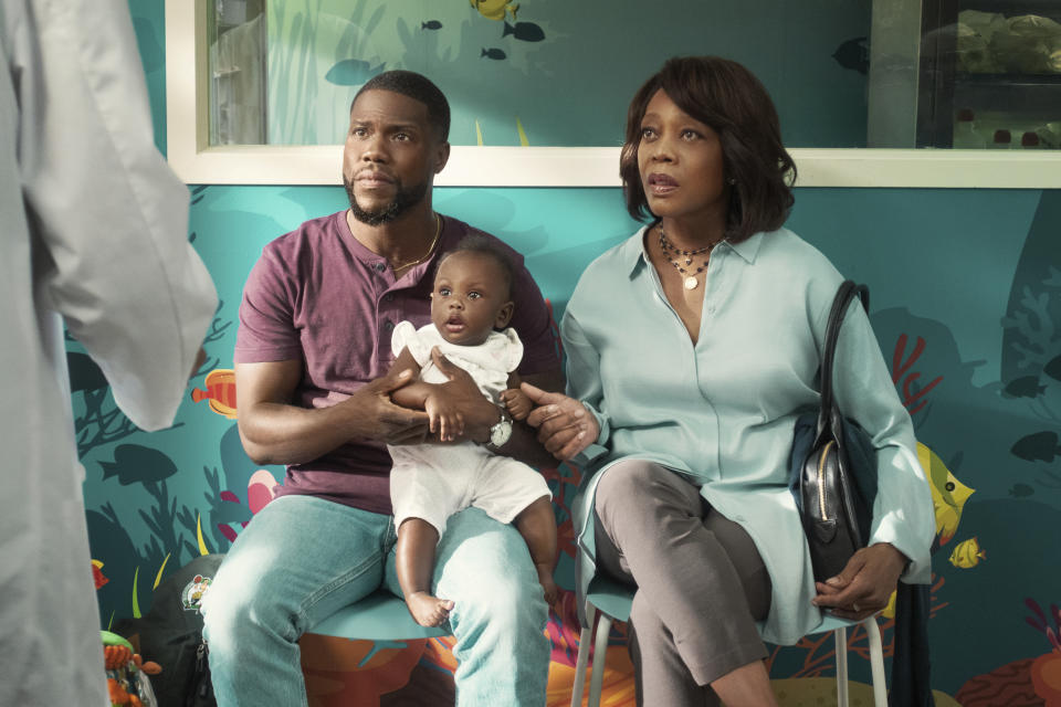 This image released by Netflix shows Kevin Hart, left, and Alfre Woodard in a scene from "Fatherhood." (Philippe Bosse/Netflix via AP)