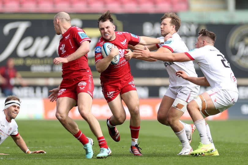 The Scarlets' Ioan Lloyd challenges the Ulster defence -Credit:Chris Fairweather/Huw Evans Agency