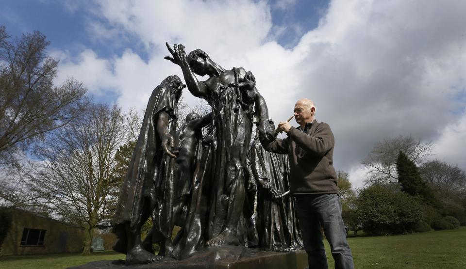 Conservator Rupert Harris waxes Rodin's 'The Burghers of Calais' after it is installed at The Henry Moore Foundation in Much Hadham, Hertfordshire, Monday, March 18, 2013. The sculpture, which normally stands outside Parliament in London, was installed to go on show in 'Moore Rodin' a major exhibition bringing together work from the two artists.(AP Photo/Kirsty Wigglesworth)