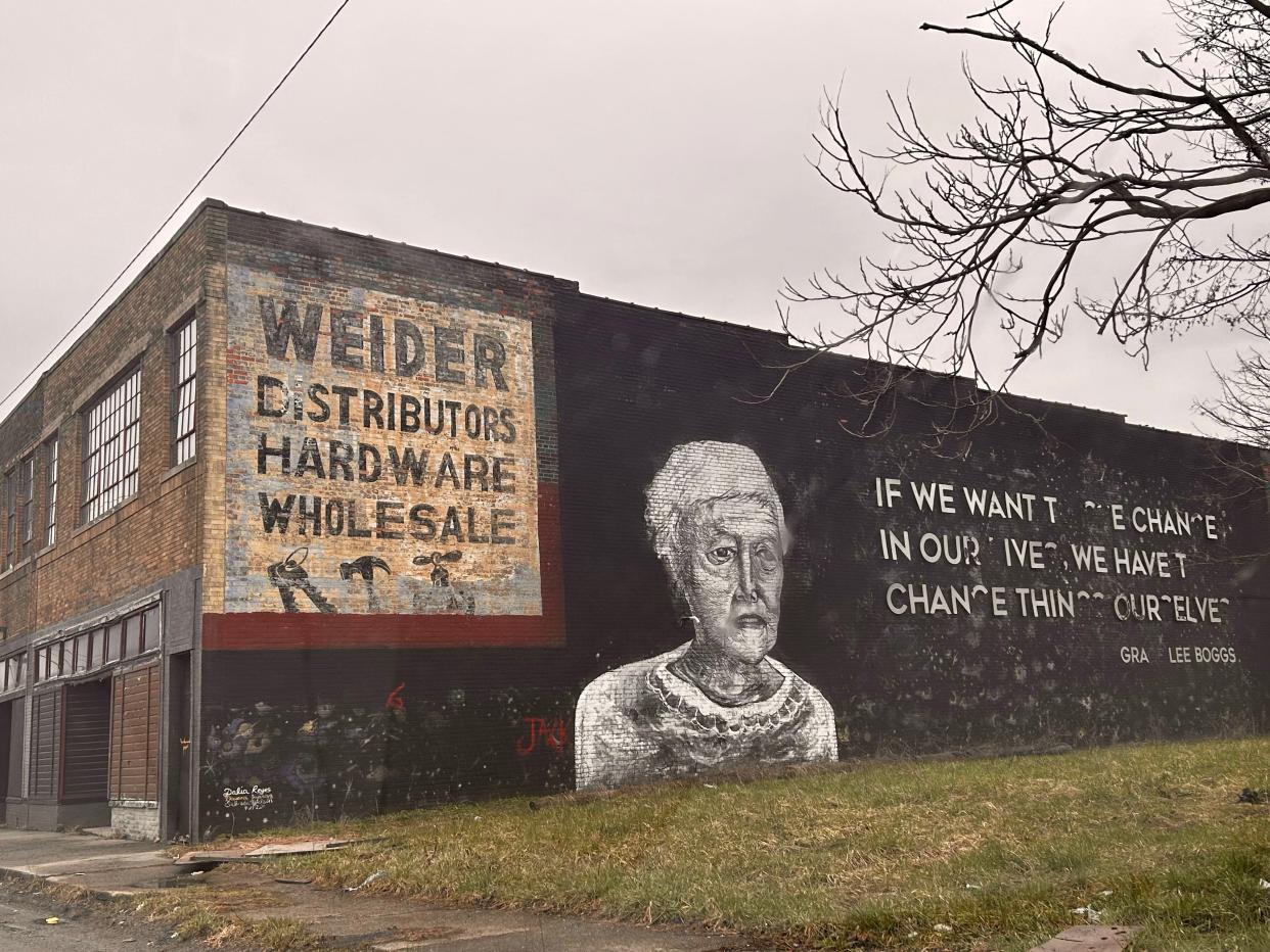 A mural in honor of activist Grace Lee Boggs is strategically placed around the ghost sign advertising the late Weider Distributors Hardware Wholesale at 6187 Lincoln Street.