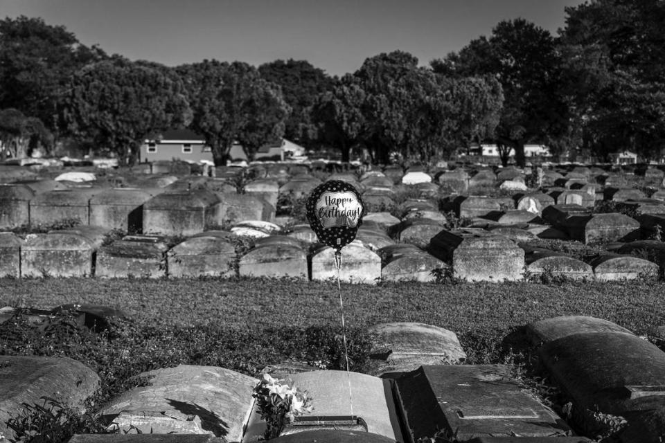 A balloon is attached to the tombstone of Vivian Wooden in celebration of her birthday (Dec. 12, 1932). She was the mother of the current owner of Lincoln Memorial Park Cemetery in Miami-Dade’s Brownsville neighborhood. Jessie Wooden found his mother’s final resting place in the neglected but once beautiful cemetery.