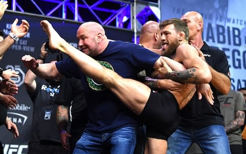 McGregor aims a kick at Nurmagomedov during their weigh-in - Credit: Jeff Bottari/Zuffa LLC