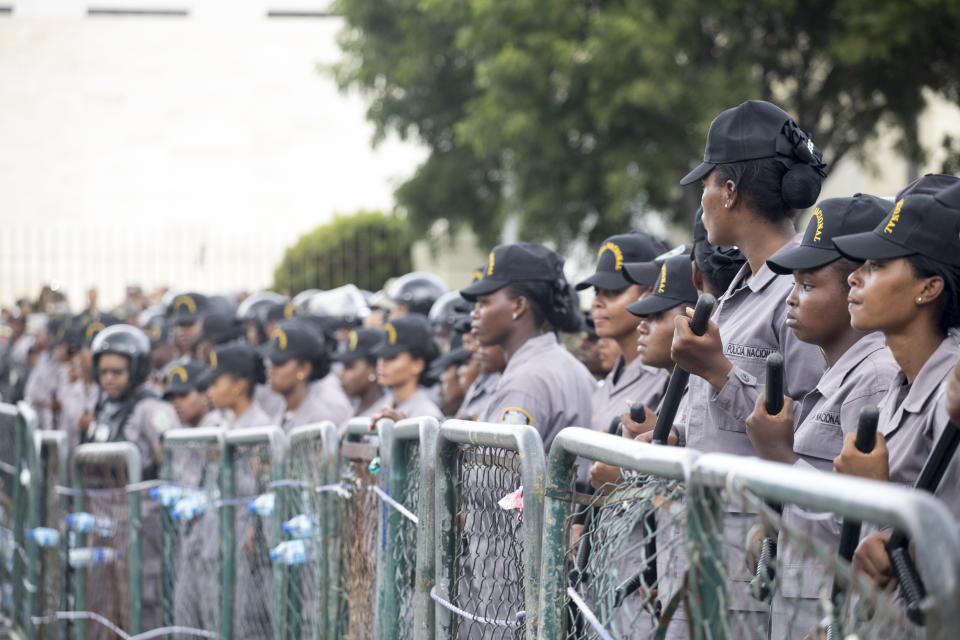 Police block access to the the National Congress during a protest against a Constitutional reform that would allow President Danilo Medina a third term in office, in front of the National Congress in Santo Domingo, Dominican Republic, Wednesday, June 26, 2019. The proposal has provoked protests from Dominicans who call it backsliding on a young democracy that emerged from decades of brutal dictatorship. (AP Photo/Tatiana Fernandez)