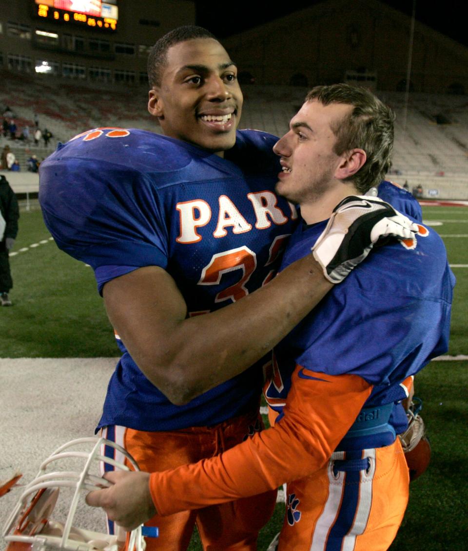 Racine Park's John Clay (left) gives teammate Dan Gustin a celebratory hug after Parks 28-9 win over Wisconsin Rapids Lincoln in the D1 state title game at Camp Randall in 2005.