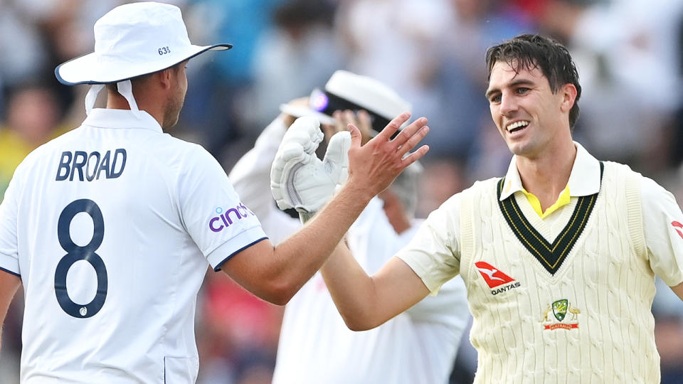 Stuart Broad and Pat Cummins embrace after the first Test was won.