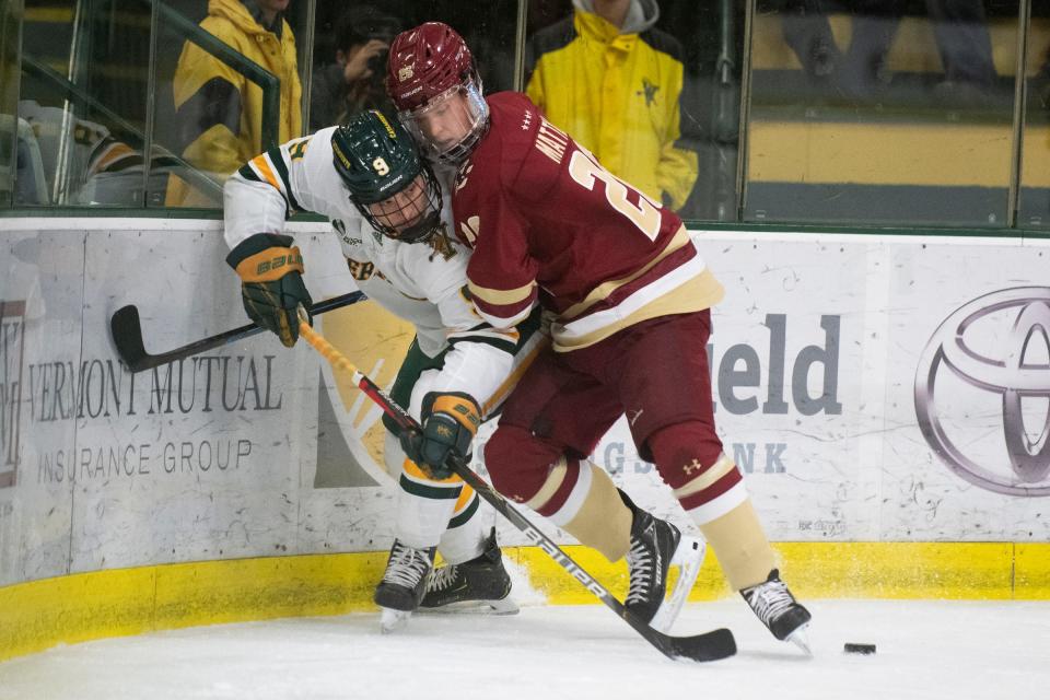 Vermont's Bryce Misley (9) and Boston College's Marc McLaughlin (25) battle for the puck during a men's hockey game between the Boston College Eagles and the Vermont Catamounts at Gutterson Field House in November, 2019 in Burlington, Vermont.