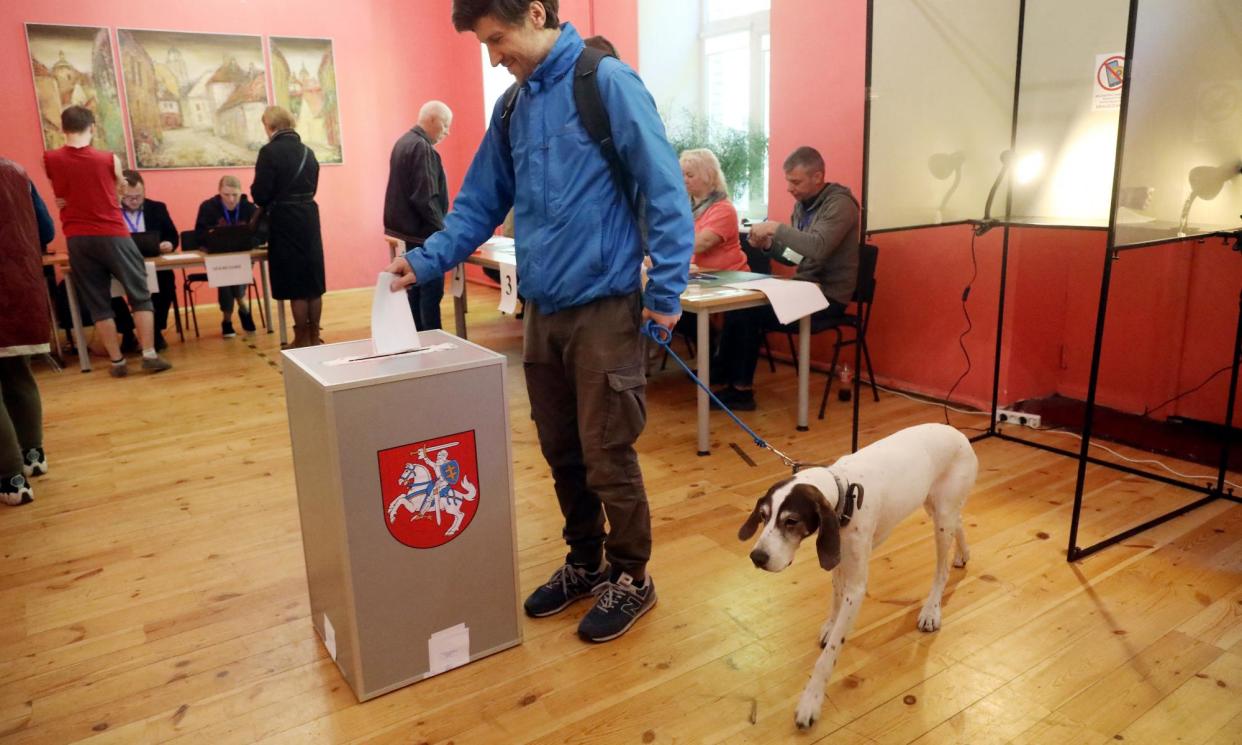 <span>Lithuania’s president, Gitanas Nausėda, casts his ballot in an election that has pitted him against prime minister Ingrida Šimonytė.</span><span>Photograph: Petras Malūkas/AFP/Getty Images</span>