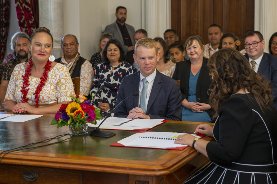 Chris Hipkins, center, is sworn in as New Zealand's next prime minister and Carmel Sepuloni, left, as deputy prime minister by Governor-General Dame Cindy Kiro, right, at Government House in Wellington, Wednesday, Jan. 25, 2023. Hipkins, 44, has promised a back-to-basics approach focusing on the economy and what he described as the "pandemic of inflation." (Mark Mitchell/New Zealand Herald via AP)