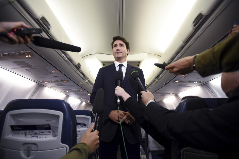 Canadian Prime Minister and Liberal Party leader Justin Trudeau makes a statement in regards to a photo coming to light of himself from 2001, wearing "brownface," during a scrum on his campaign plane in Halifax, Nova Scotia, Wednesday, Sept. 18, 2019. (Sean Kilpatrick/The Canadian Press via AP)