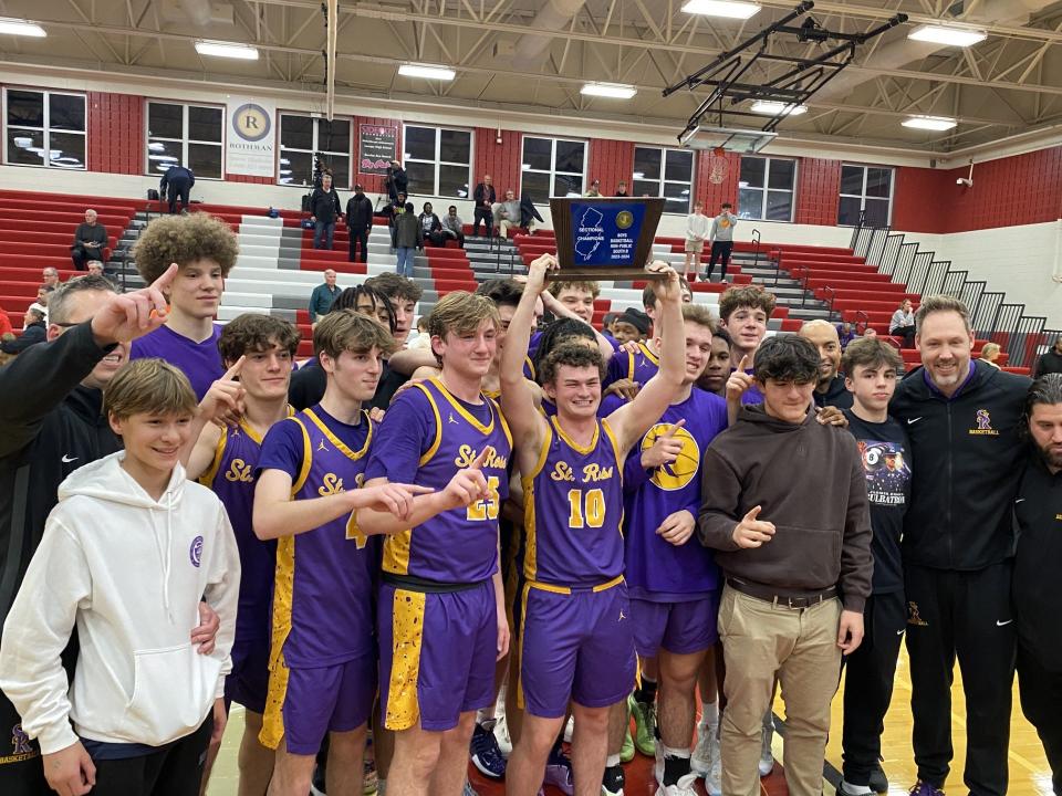 St. Rose players and coaches celebrate after winning the NJSIAA South Non-Public B sectional championship, topping Bishop Eustace, 82-40, Monday night at Lenape High School.