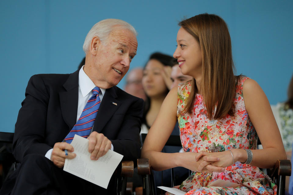 Former U.S. Vice President Joe Biden talks to graduating student Katherine Wu (R) during Class Day Exercises at Harvard University in Cambridge, Massachusetts, U.S., May 24, 2017, ahead of the University's 366th Commencement Exercises May 25.   REUTERS/Brian Snyder