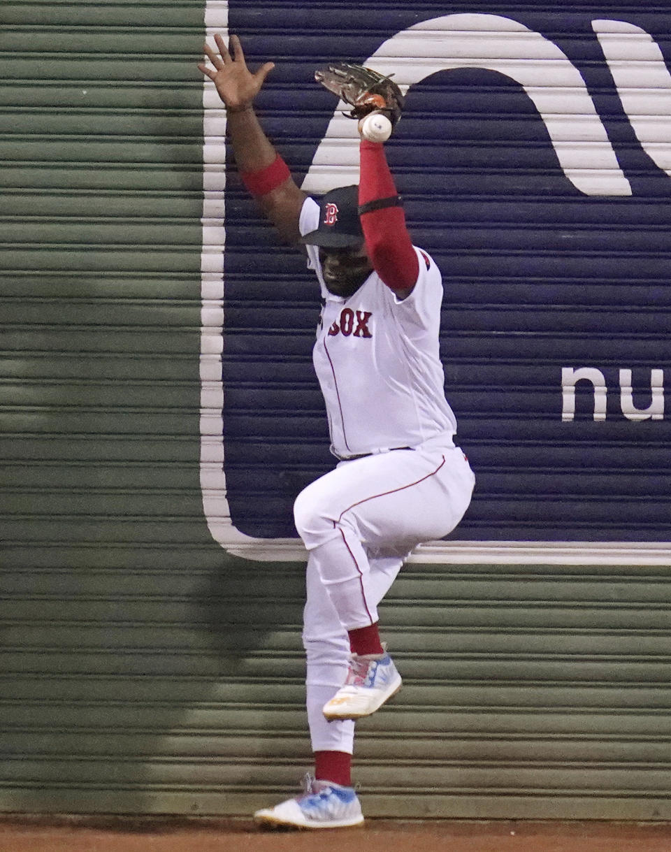 Boston Red Sox center fielder Abraham Almonte misplays the catch on a deep drive by New York Yankees' Gleyber Torres, which drove in a run, during the ninth inning of a baseball game at Fenway Park, Wednesday, Sept. 14, 2022, in Boston. Almonte was charged with an error on the play. (AP Photo/Charles Krupa)