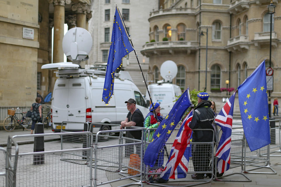 Anti-Brexit protestors hold British and European flags as they demonstrate outside the London TV studios prior to a Live TV debate by Conservative Party candidates in London, Tuesday, June 18, 2019. Britain's Conservative Party will continue to hold elimination votes until the final two contenders will be put to a vote of party members nationwide, with the winner due to replace Prime Minister Theresa May as party leader and prime minister. (AP Photo/Vudi Xhymshiti)