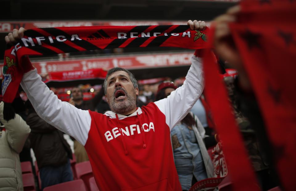 Supporters sing as the funeral car containing Eusebio's coffin cross the Luz stadium in Lisbon