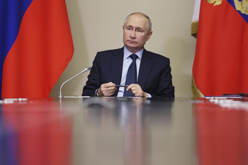 FILE - Russian President Vladimir Putin leads a meeting at the Novo-Ogaryovo State residence outside Moscow, Russia, on Oct. 16, 2023. Vladimir Putin on Friday Dec. 8, 2023 moved to prolong his repressive and unyielding grip on Russia for another six years, announcing his candidacy in the 2024 presidential election that he is all but certain to win. (Gavriil Grigorov, Sputnik, Kremlin Pool Photo via AP, File)