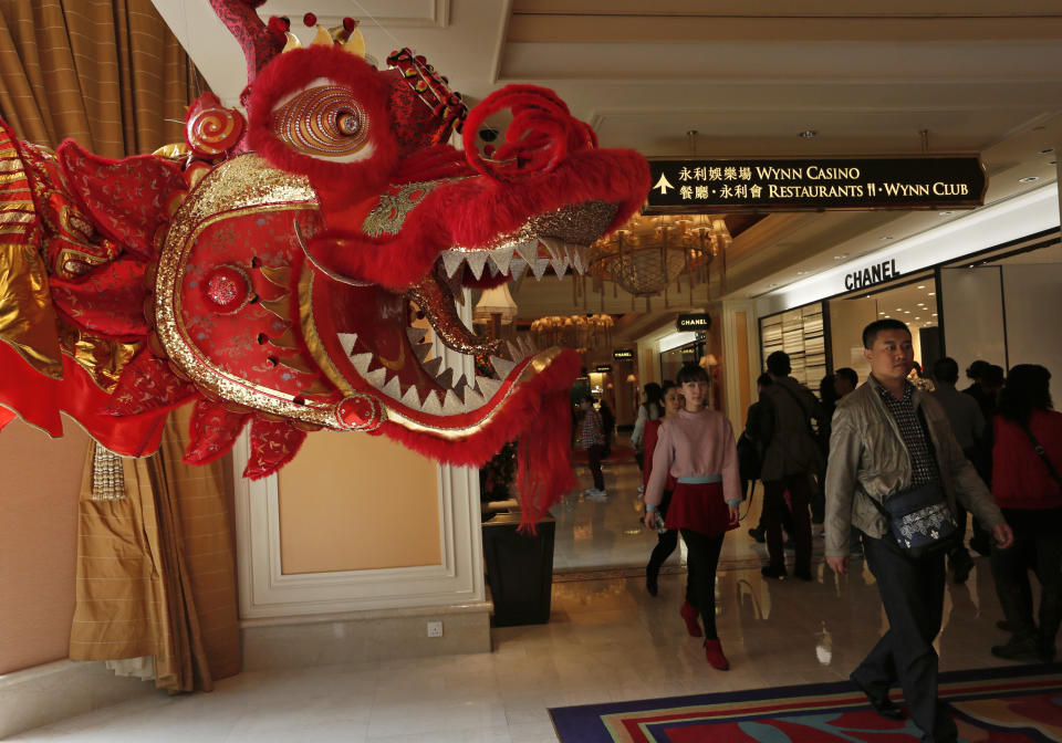 In this Feb. 1, 2014 photo, mainland Chinese tourists walk at the lobby of Wynn Macau casino during a Chinese New Year celebration in Macau. The annual holiday is the busiest time of year for the former Portuguese colony, which became a special Chinese region in 1999. Many of the millions of mainland Chinese on the move during the holiday, often referred to as the world’s biggest migration, head to Macau during the festival. (AP Photo/Vincent Yu)