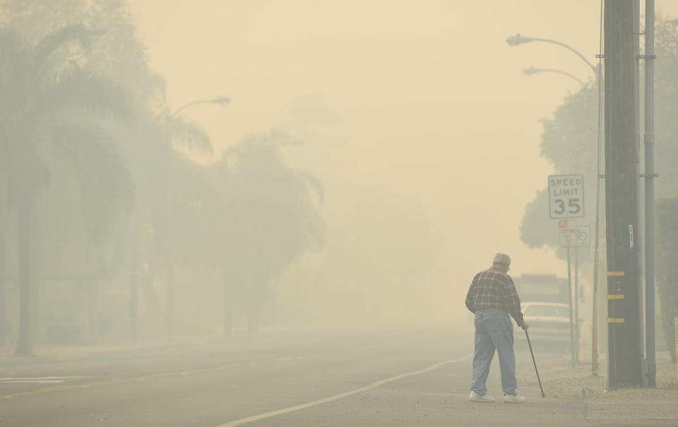 <span class="caption">Exposure to wildfire smoke can also harm the lungs, heart and brain.</span> <span class="attribution"><a class="link " href="https://www.gettyimages.com/detail/news-photo/man-walks-along-ventura-ave-as-the-thomas-fire-leaves-smoke-news-photo/888932848" rel="nofollow noopener" target="_blank" data-ylk="slk:Wally Skalij/Los Angeles Times via Getty Images;elm:context_link;itc:0;sec:content-canvas">Wally Skalij/Los Angeles Times via Getty Images</a></span>