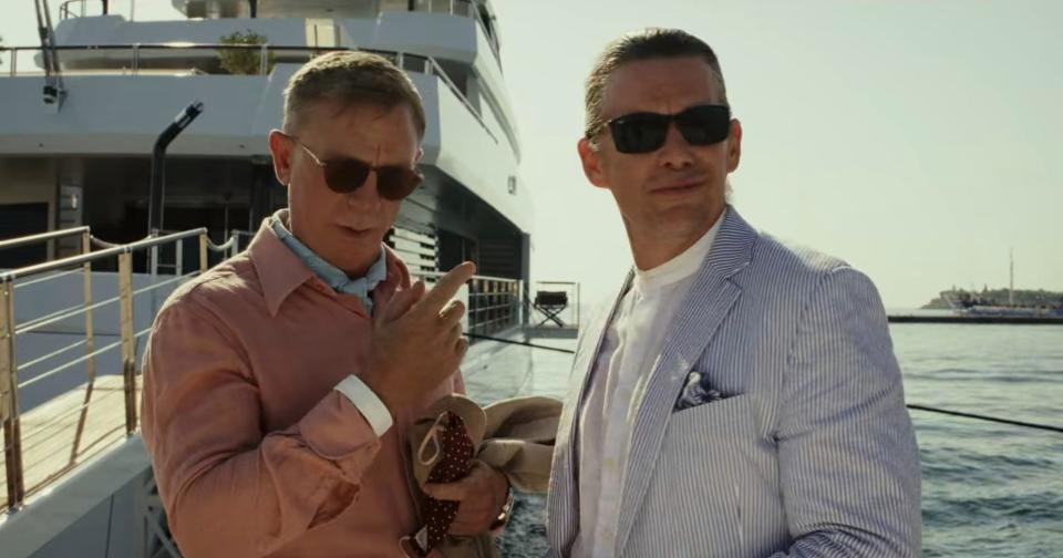 Daniel Craig standing next to a smiling Ethan Hawke