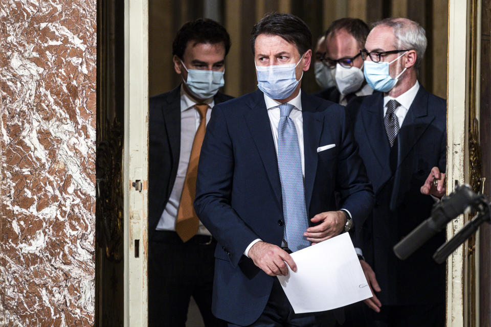 Italian Premier Giuseppe Conte arrives to announce new restrictions to curb the spread of coronavirus, in Rome, Wednesday, Nov. 4, 2020. Four regions in Italy are being put under severe lockdown, forbidding people to leave their homes except for essential reasons such as food shopping and work in a bid to slow surging COVID-19 infections and prevent hospitals from being overwhelmed. Premier Giuseppe Conte on Wednesday night announced what he described as “very stringent” restrictions on the so-called “red zone” regions of high risk: Lombardy, Piedmont, Valle d’Aosta in the north and Calabria, the region forming the “toe” in the south of the Italian peninsula. (Angelo Carconi/Pool Photo via AP)