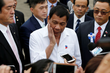 Philippine President Rodrigo Duterte (C) speaks to the media after his inspection at Japan Coast Guard base in Yokohama, south of Tokyo, Japan October 27, 2016. REUTERS/Issei Kato