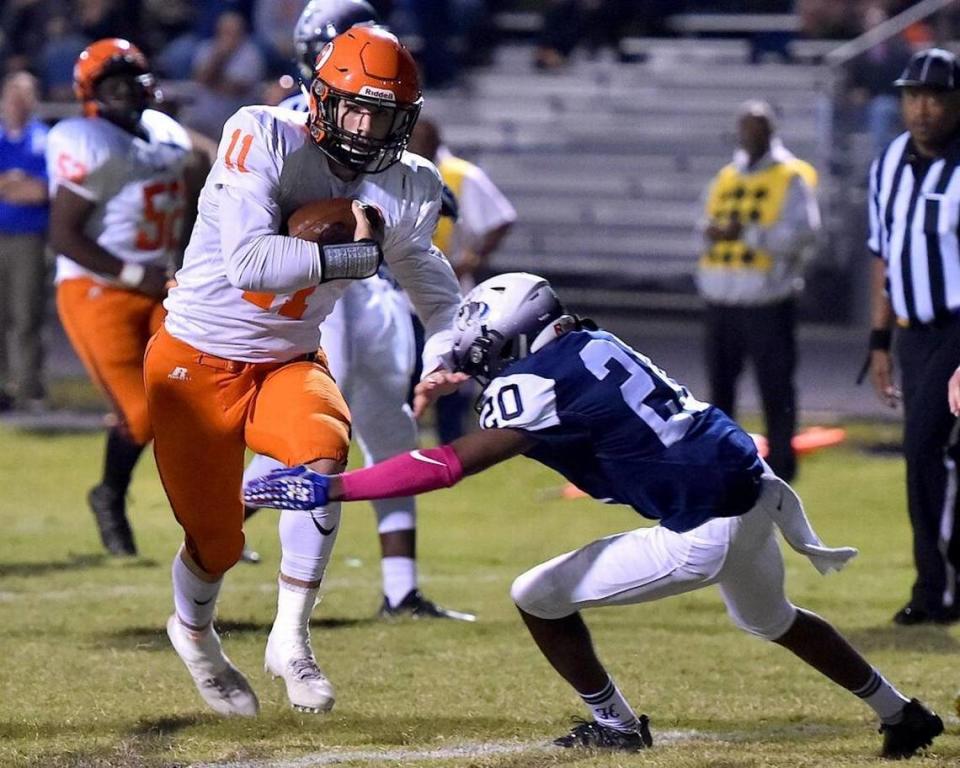 Orange’s Payton Wilson (11) runs the ball in for the touchdown while defended by Hillside’s Chris Rogers (20). The Orange Panthers visited the Hillside Hornets in a high school football game on Oct. 13, 2017. Orange wins 31-20.