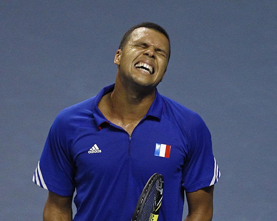 French tennis player Jo-Wifried Tsonga grimaces after missing a point during his single match against German player Peter Gojowczyk, in the quarterfinals of the Davis Cup in Nancy, eastern France, Friday April 4, 2014. France plays against Germany from Friday April 4 to Sunday April 6. (AP Photo/Remy de la Mauviniere)