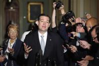 Reporters gather around U.S. Senator Ted Cruz (R-TX) as he announces he will not filibuster, after a Republican Senate caucus meeting at the U.S. Capitol in Washington, October 16, 2013. REUTERS/Jonathan Ernst