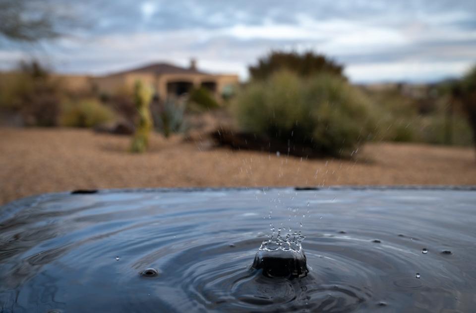 Karen Nabity, a resident of Rio Verde Foothills, collects rainwater for use in her home, Dec. 29, 2022.