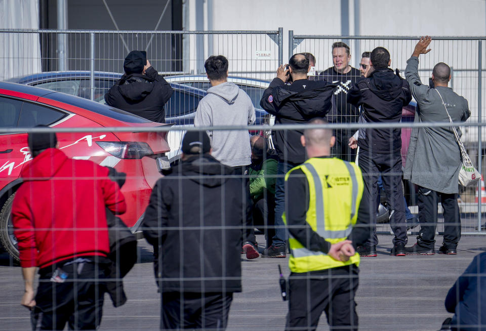 Tesla CEO Elon Musk, 4th from right, arrives at the Tesla Gigafactory for electric cars in Gruenheide near Berlin, Germany, Wednesday, March 13, 2024. Power has been restored to electric car manufacturer Tesla's factory near Berlin about a week after an outage believed to have been caused by arson, a network operator says. (AP Photo/Ebrahim Noroozi)