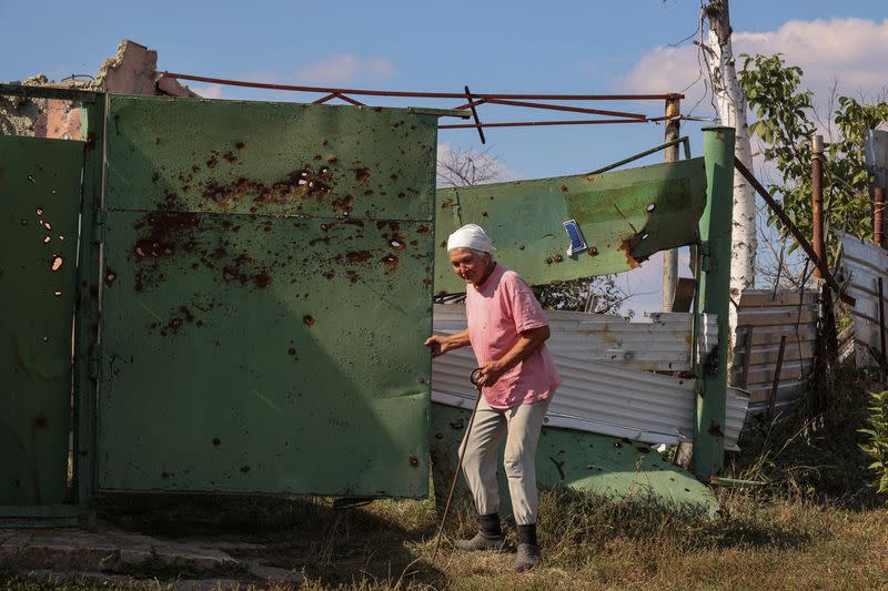 Vira Chernukha at her damaged house in the village of Dementiivka in Kharkiv region