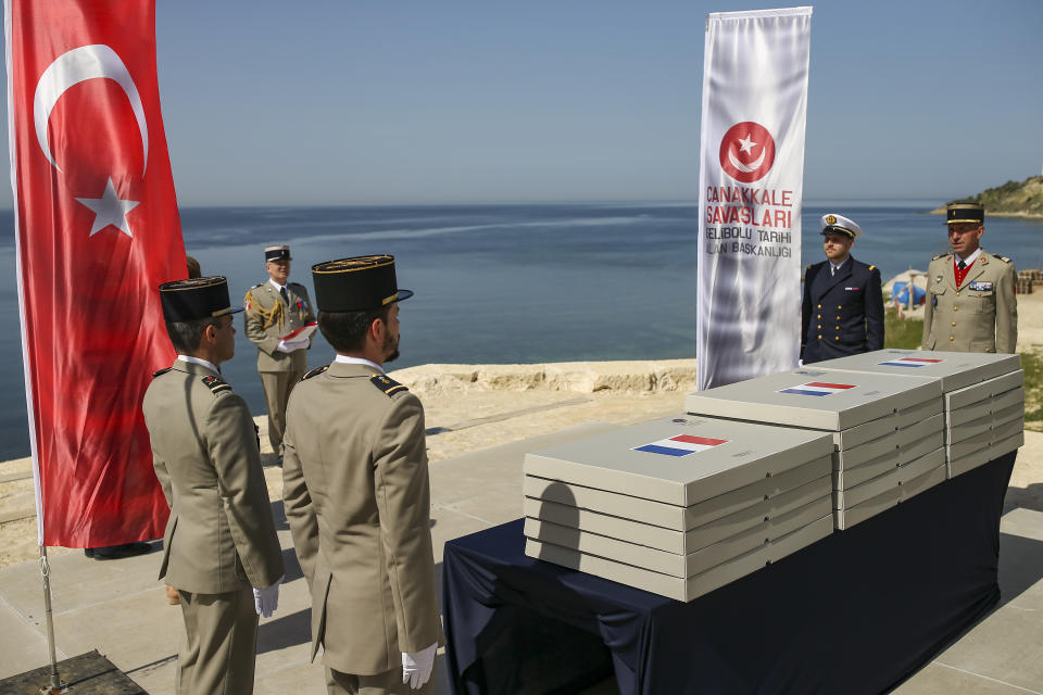 French army officers prepare the remains of 17 missing French soldiers who fought in the World War I Battle of Gallipoli, in Canakkale, Turkey, Sunday, April 24, 2022. The remains were on Sunday handed over to French military officials and put to rest alongside other fallen comrades, more than a hundred years after their deaths. The remains were found during restoration work on a castle and surrounding areas on Turkey's northwestern Canakkale peninsula, where Allied forces fought against Ottoman Turks in the ill-fated Gallipoli campaign that started with landings on the peninsula on April 25, 1915. (AP Photo/Emrah Gurel)